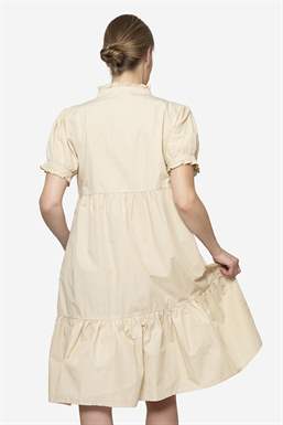 Beige loose nursing dress in organic cotton - seen from behind